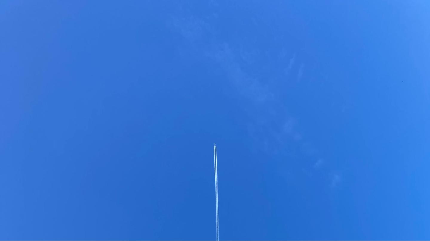 A plane going straight up into the sky.